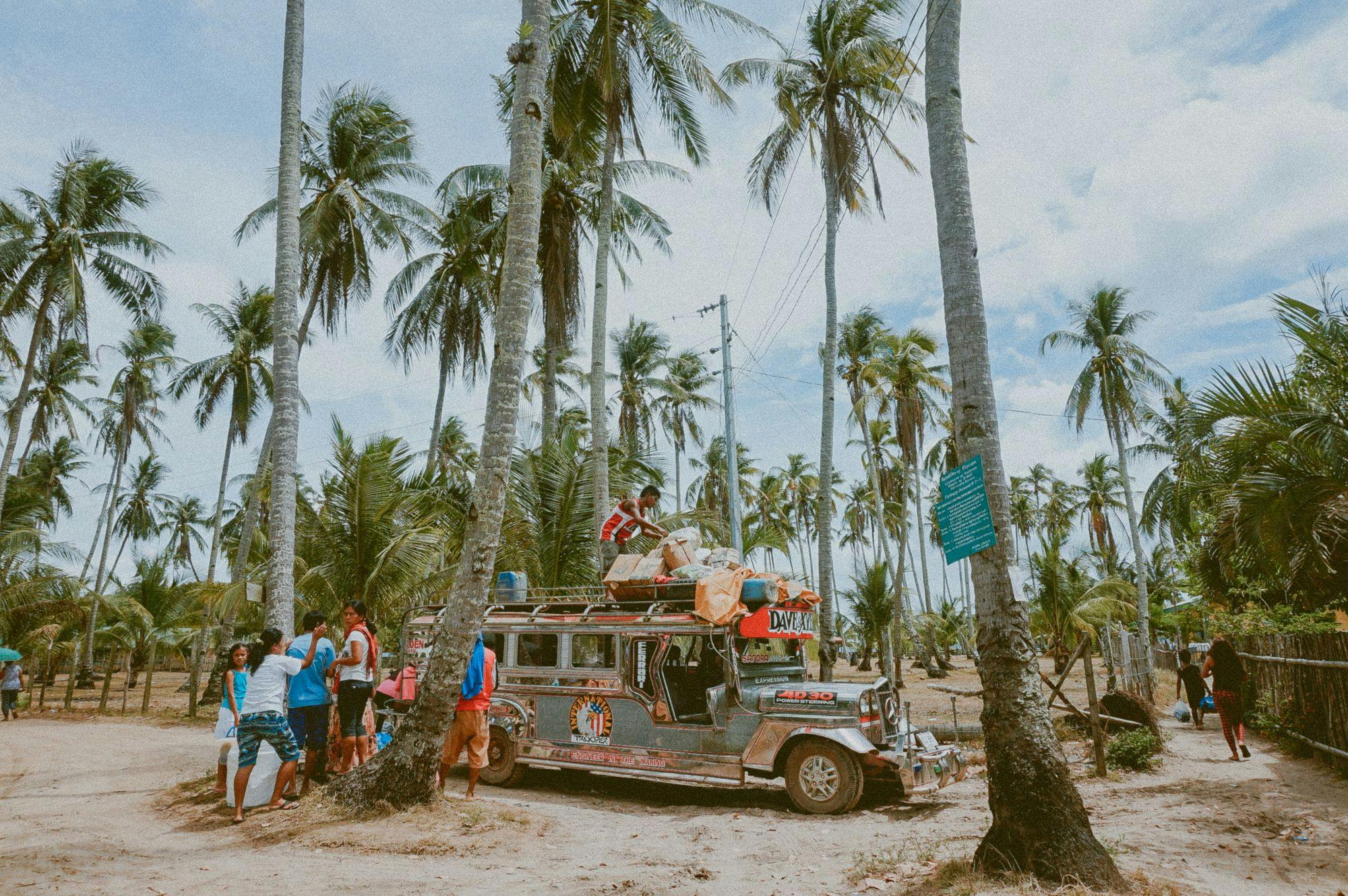 asian-travelling-campervan-palm-trees-people-standing-around